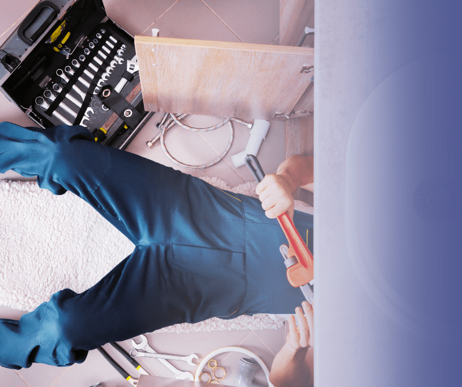 Plumber fixing sink with tools and pipes visible.