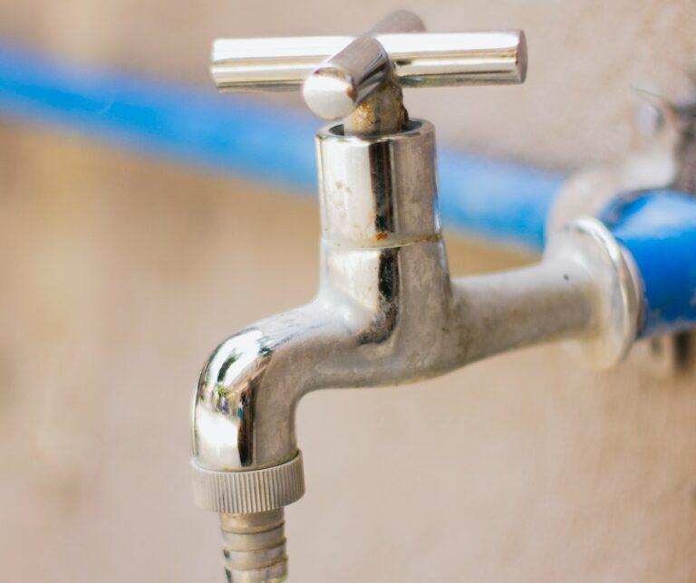 Close-up of shiny metal water faucet.