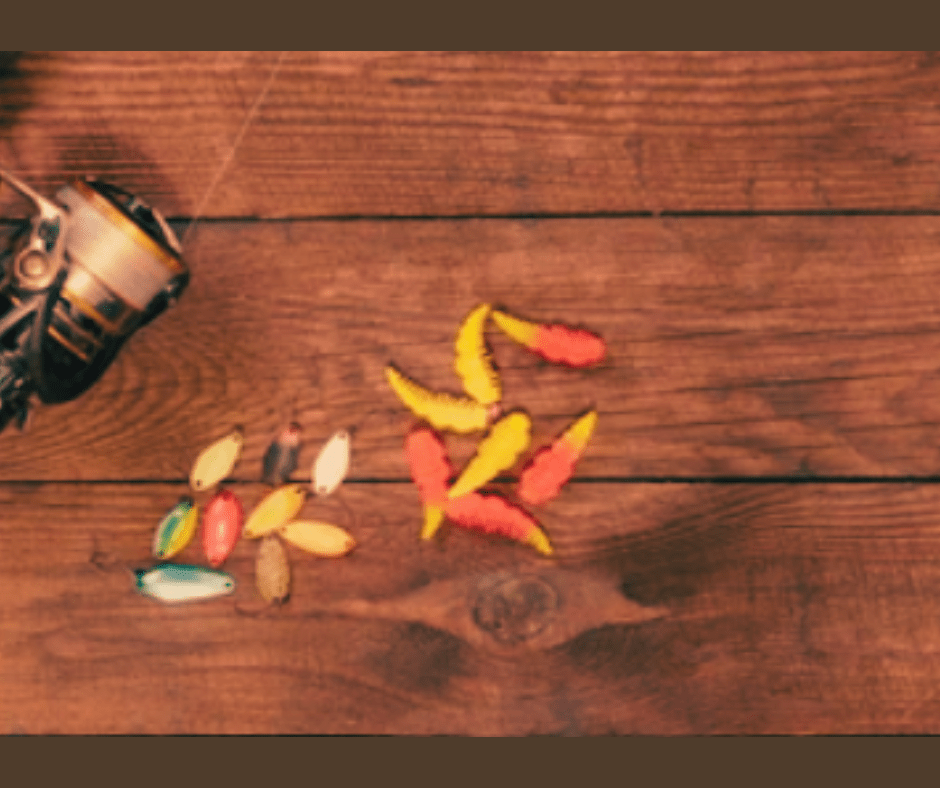 Vintage camera with colorful autumn leaves on wooden background.