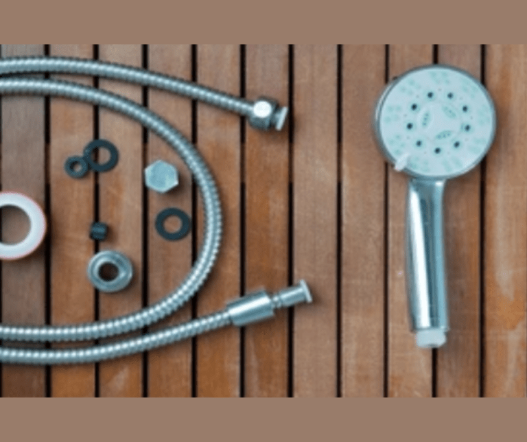 Shower head and hose parts on wooden surface.