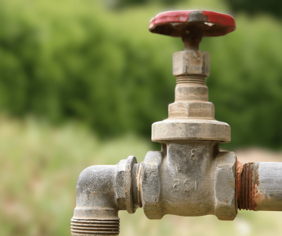 Close-up of an old outdoor water faucet.