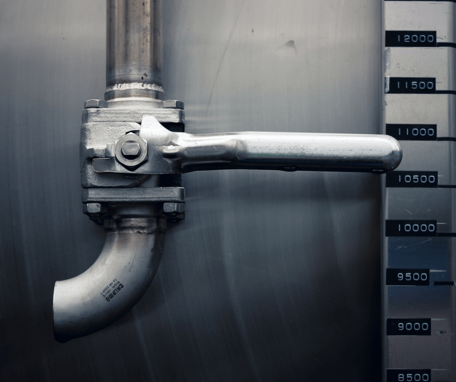 Industrial valve on metal piping with measurement indicators.