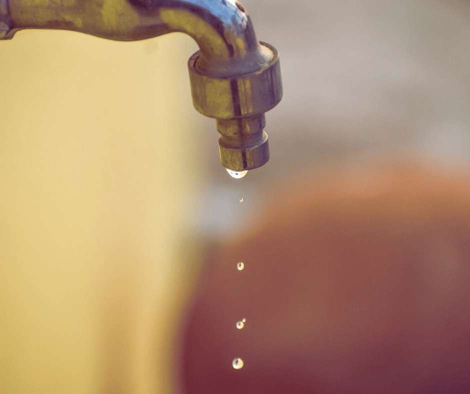 Water dripping from an outdoor tap.